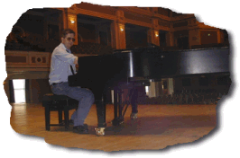 A photo of Barrie tuning the Model D Steinway in King Georges hall